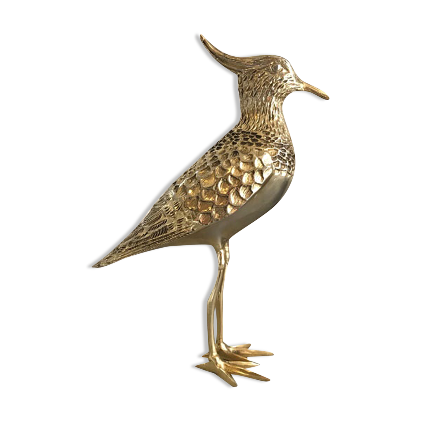 Crested bird in golden brass