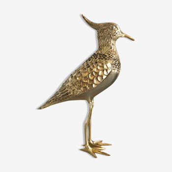 Crested bird in golden brass