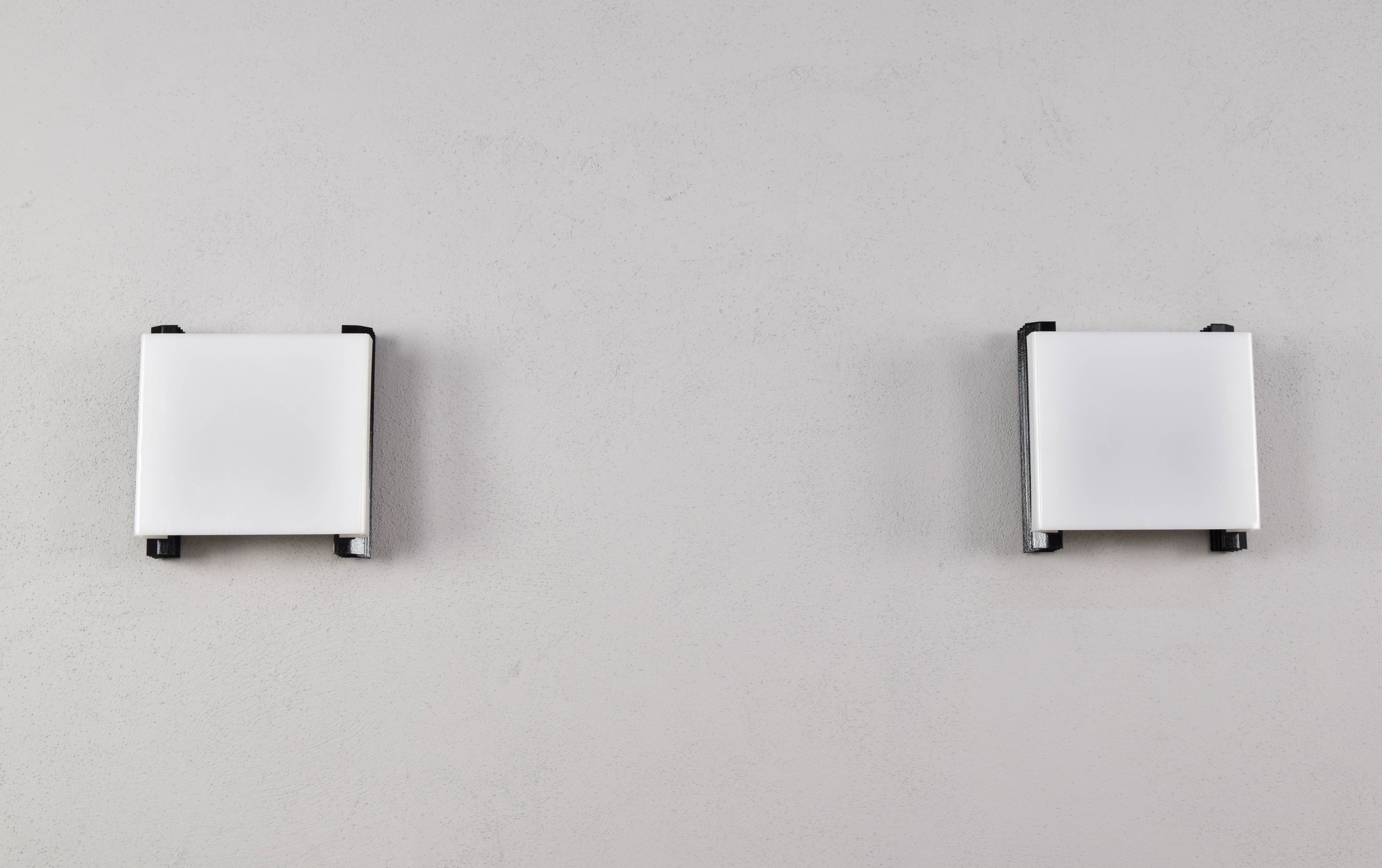 Mid-century modern sconces of black iron sheets and white lucite spain 1960s