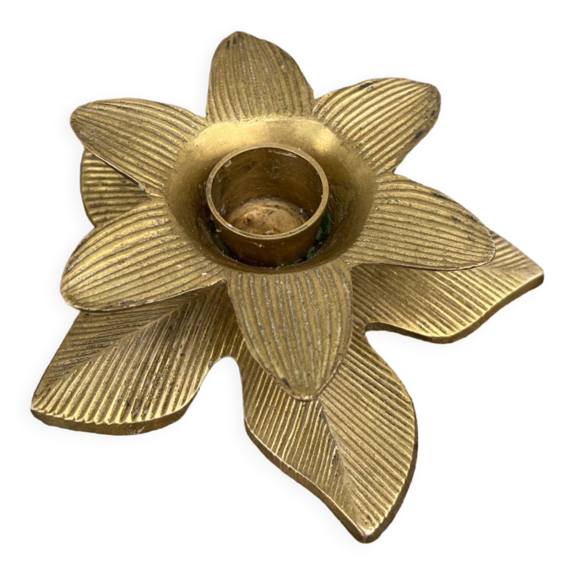 Old golden brass candle holder in the shape of a leaf or flower