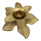 Old golden brass candle holder in the shape of a leaf or flower