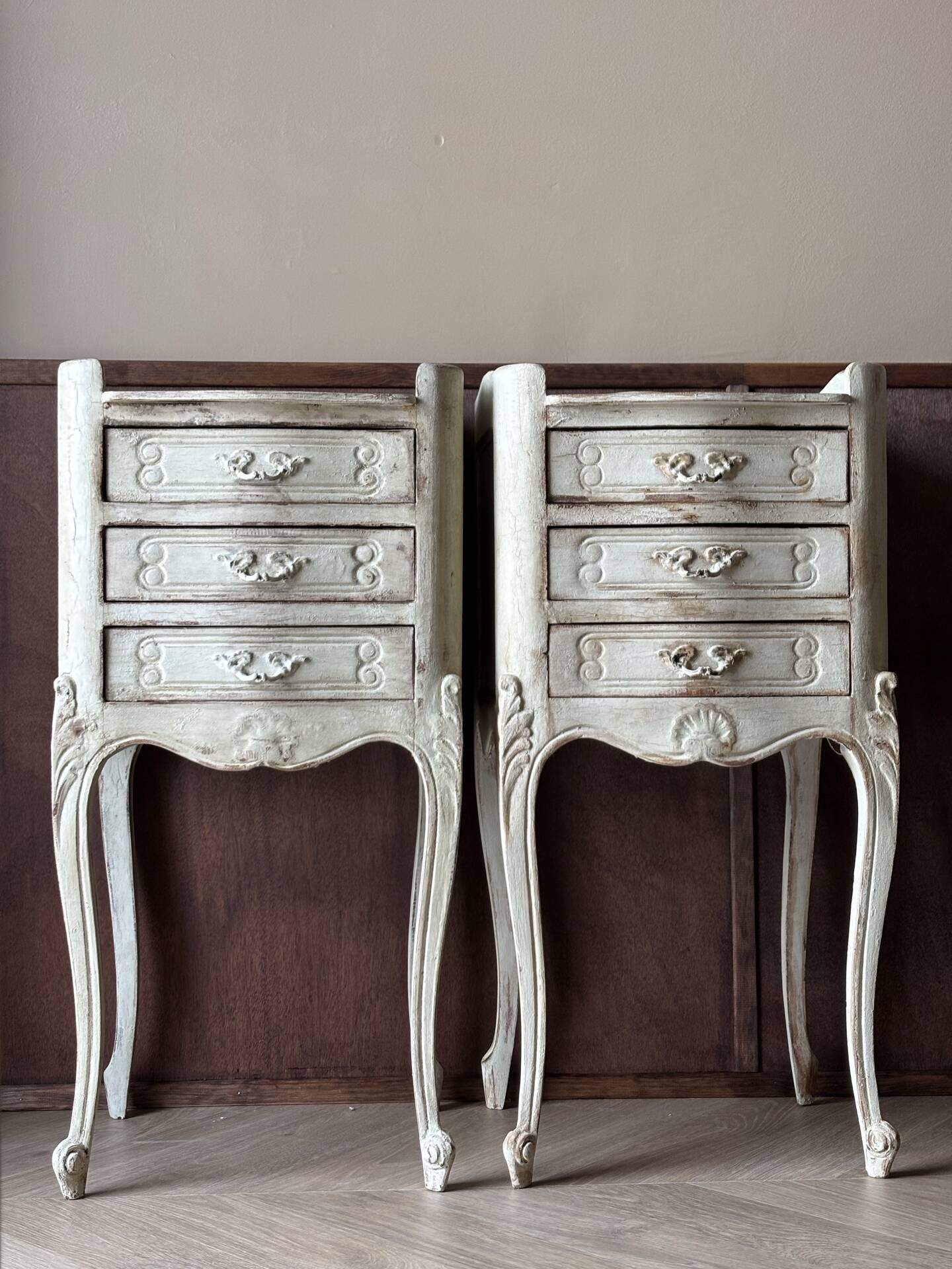 A pair of distressed bedside tables.