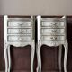 A pair of distressed bedside tables.