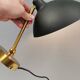 A wall lamp in black and brass-coloured finishes. Danish, early 2000s.