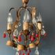 Antique chandelier in gilded sheet metal and red and white crystal pendants, 1900