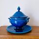 Blue ceramic soup tureen and crackled finish trivet.