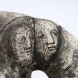 Ceramic vase sculpture decorated with faces and featuring a hole, 1980s.