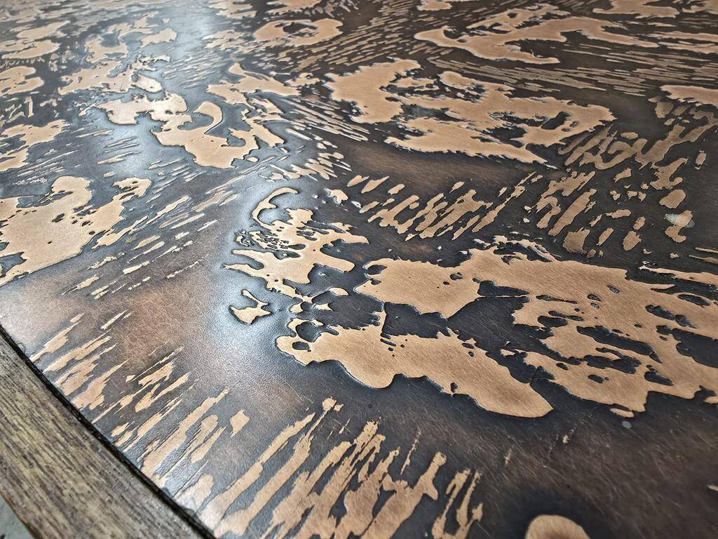 Vintage round wooden coffee table with a copper top.