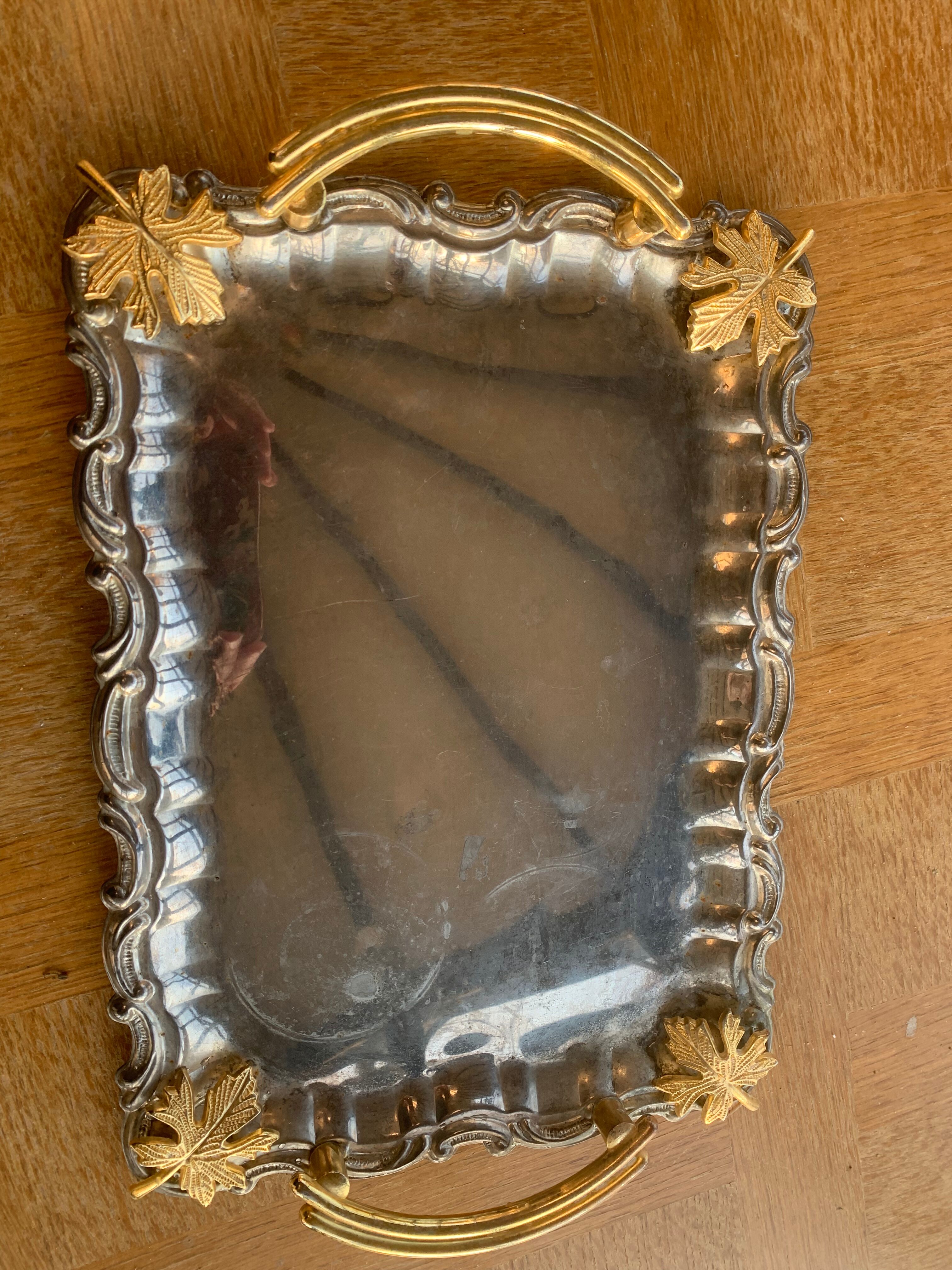 Silver metal top and decoration of foliage and handles in vintage brass