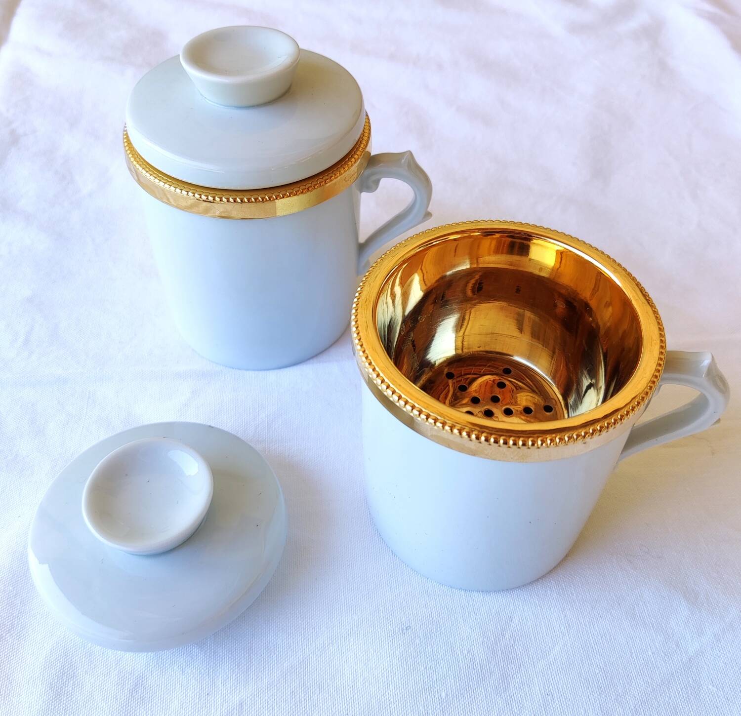 2 white and gold Limoges porcelain tea cups