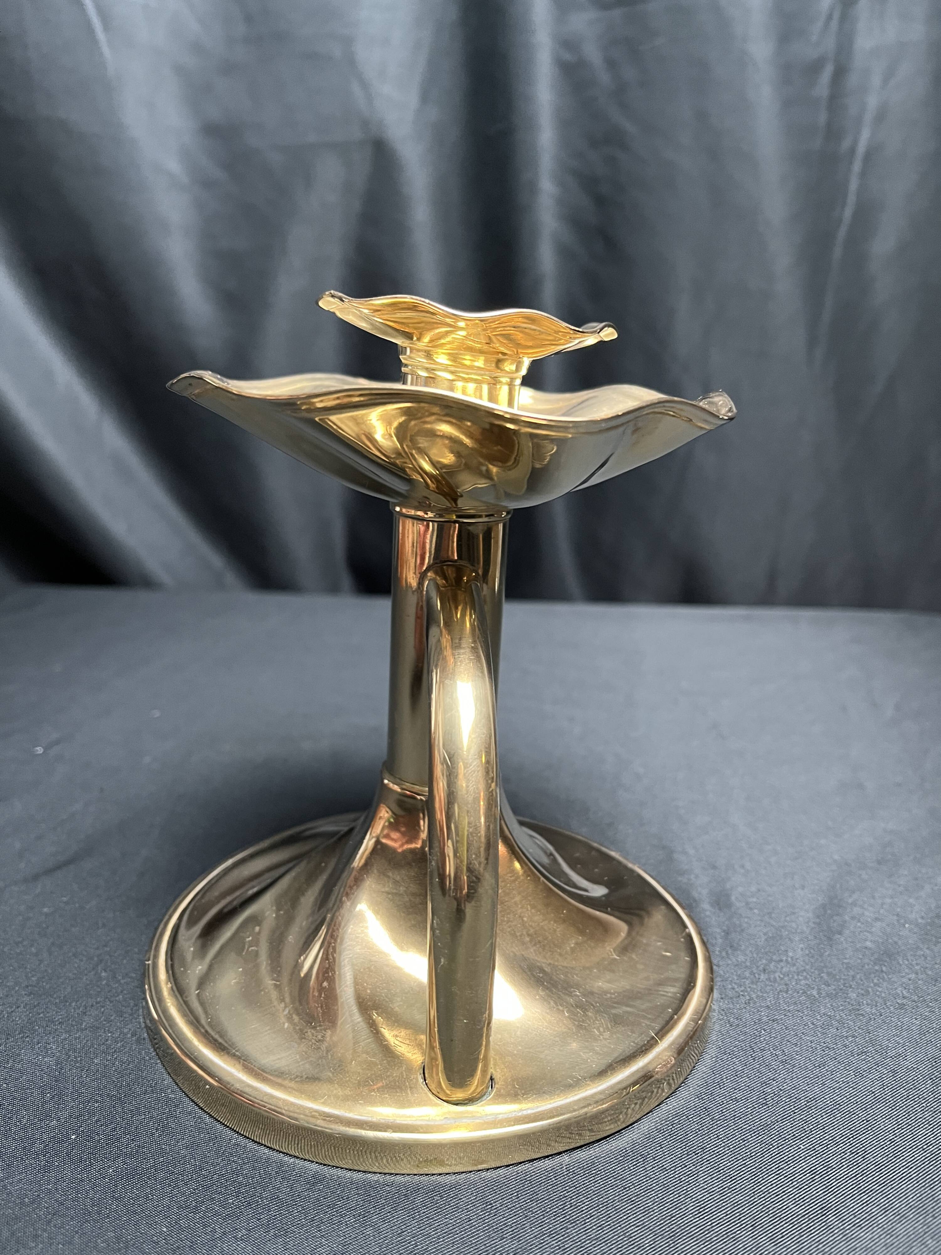 Brass candlestick in a fluted shape from the early 20th century.