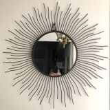 Sun mirror in black lacquered metal