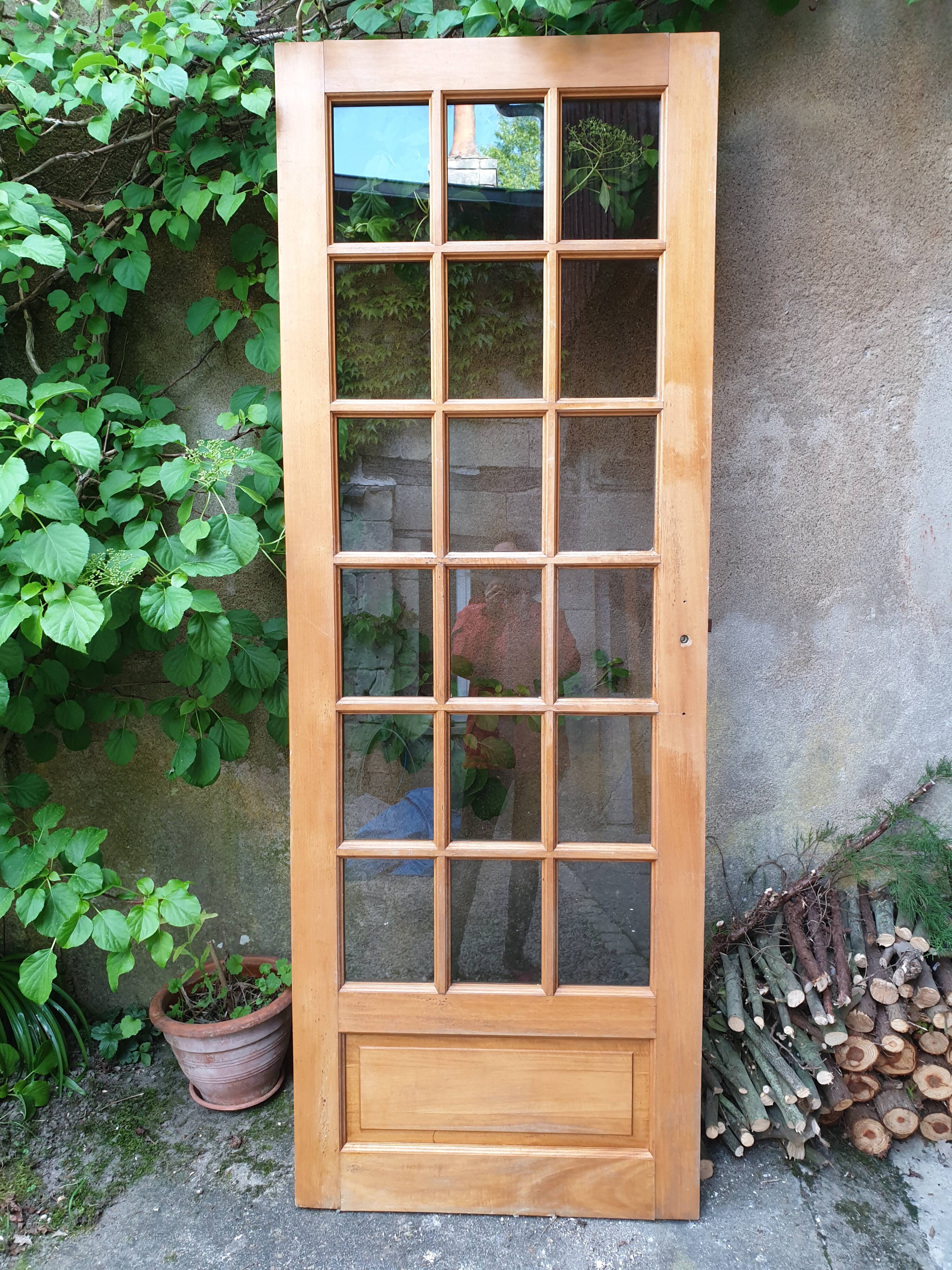 Old wooden door glazed with small tiles