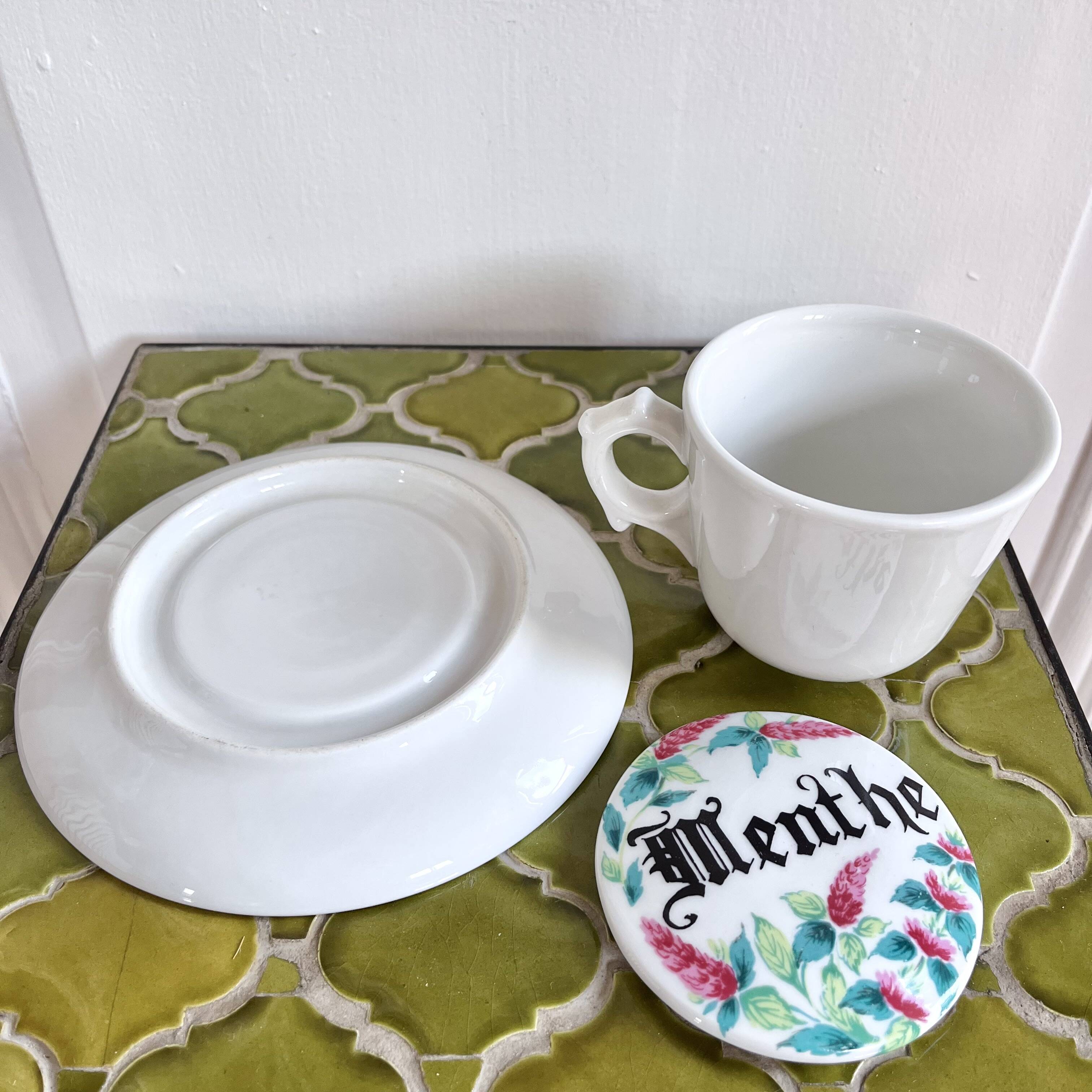 Antique herbal tea cup with mint infusion