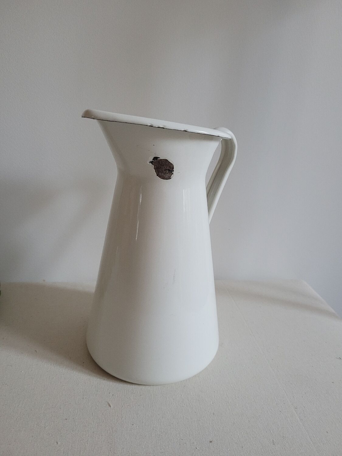 White enamelled metal jug
