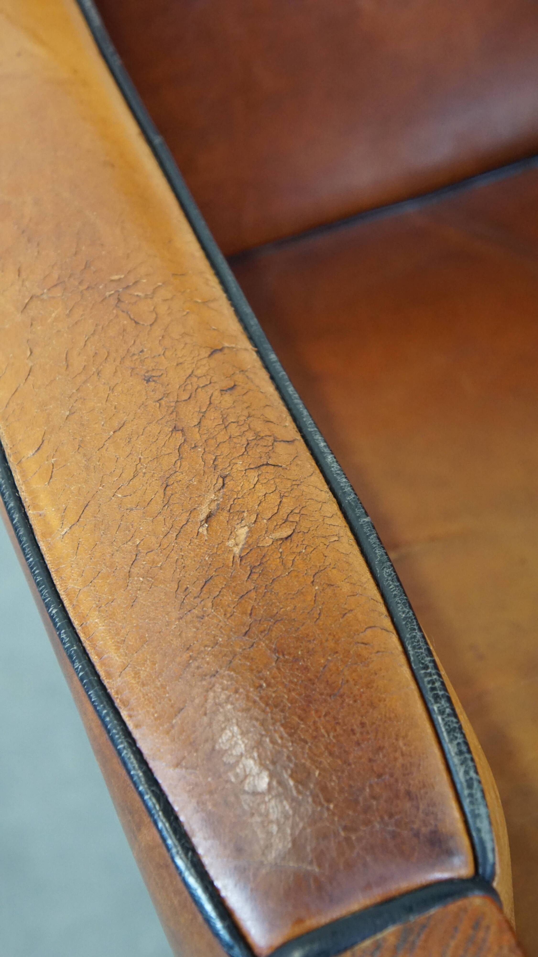 Sheep leather and wooden Art Deco design armchair with ball feet