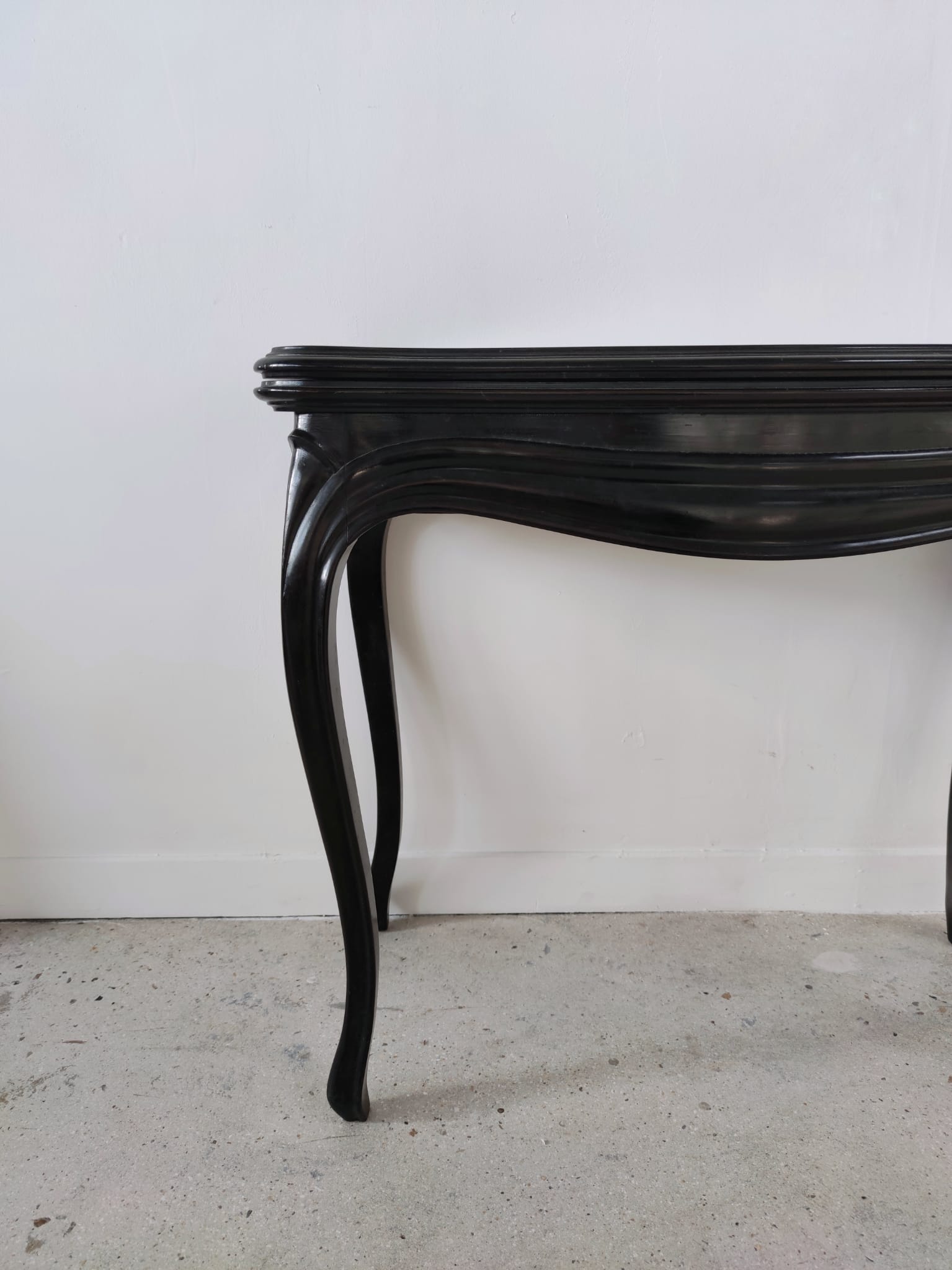 Molded blackened wooden play table, arched legs, green felt