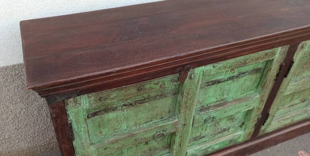 Long wooden sideboard with old green doors
