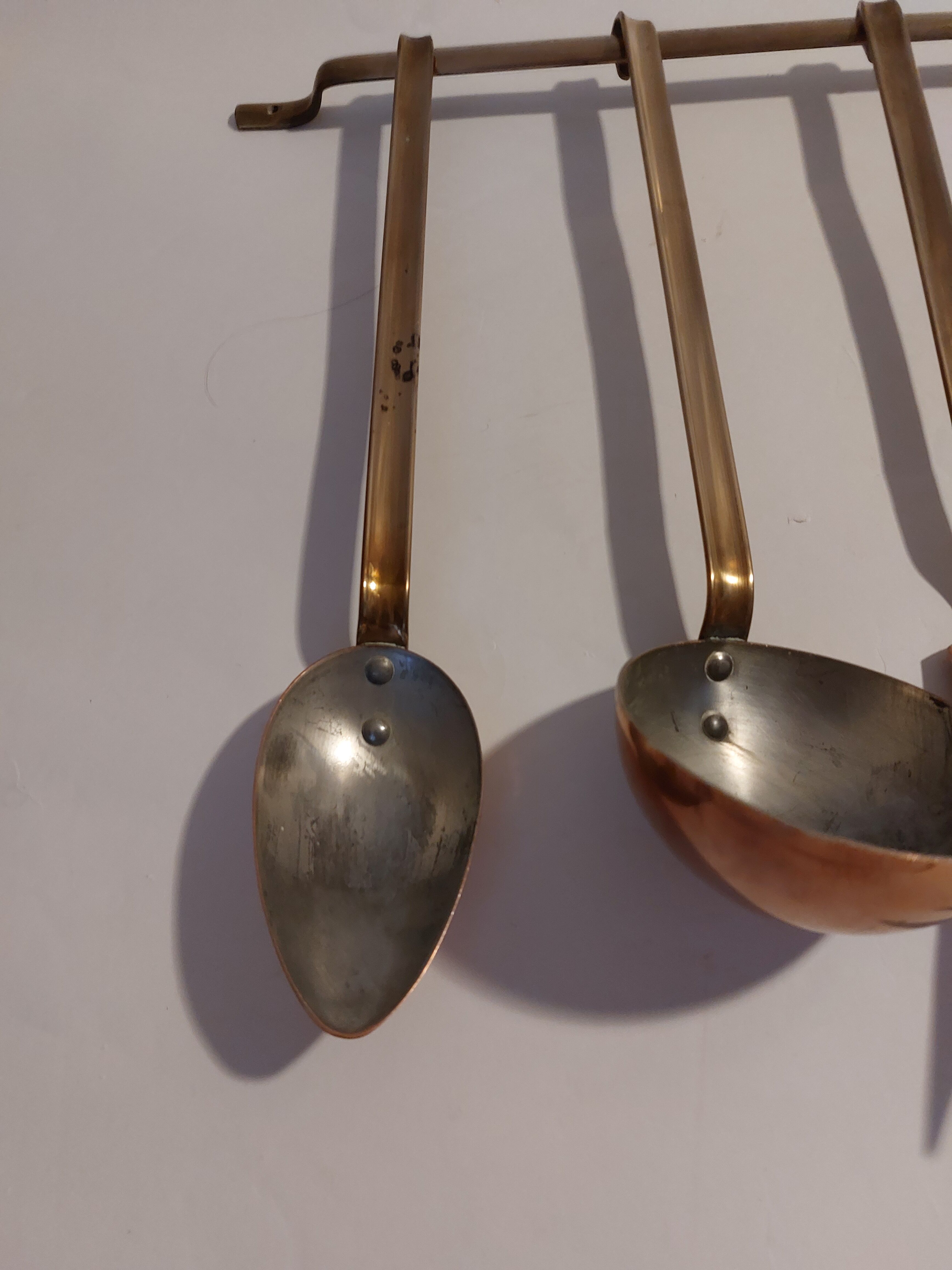 Vintage copper and brass kitchen utensils.