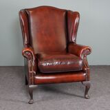 Leather armchair with decorative nails