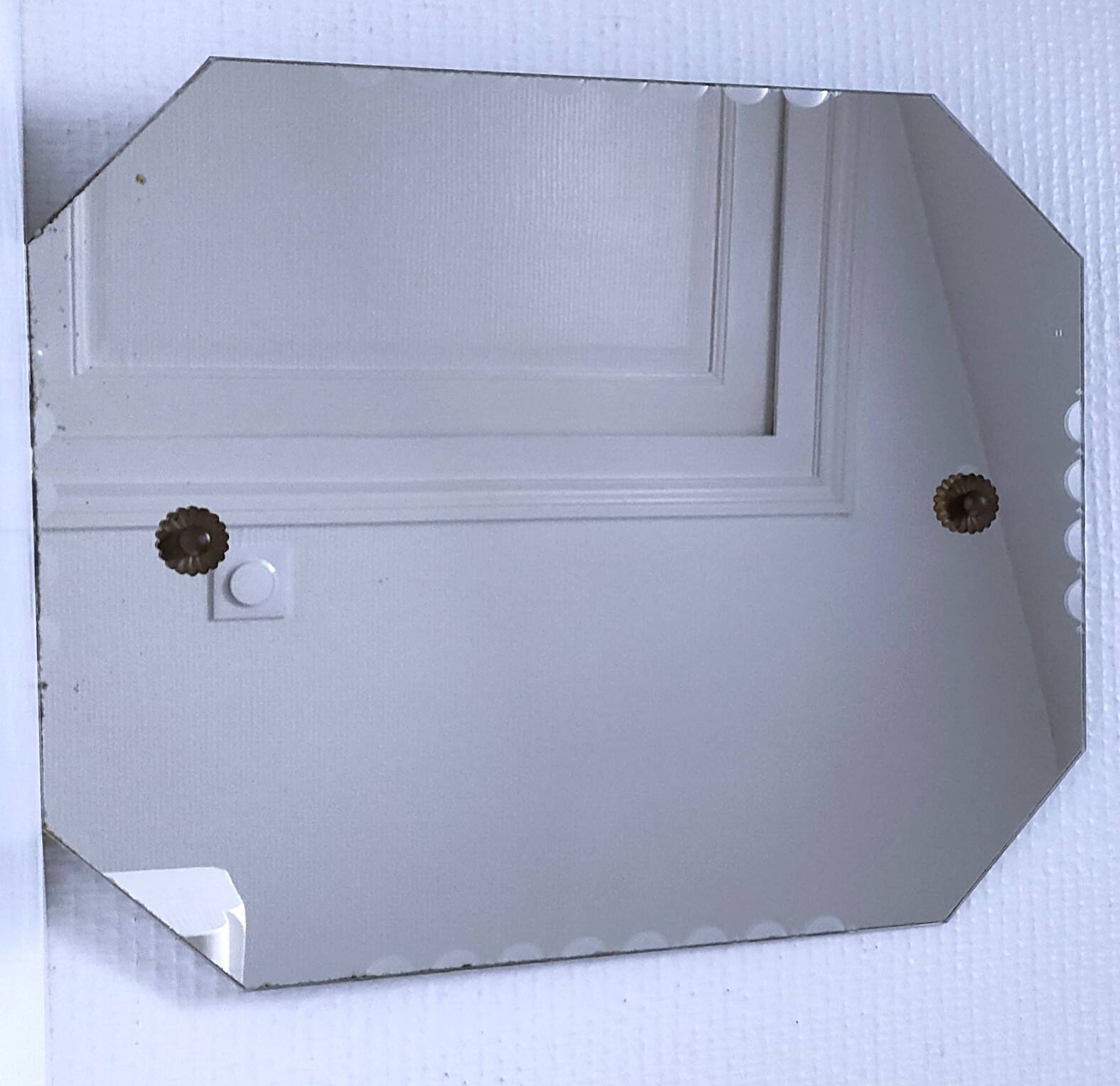 Octagonal mirror with brass hubcaps from the 60s