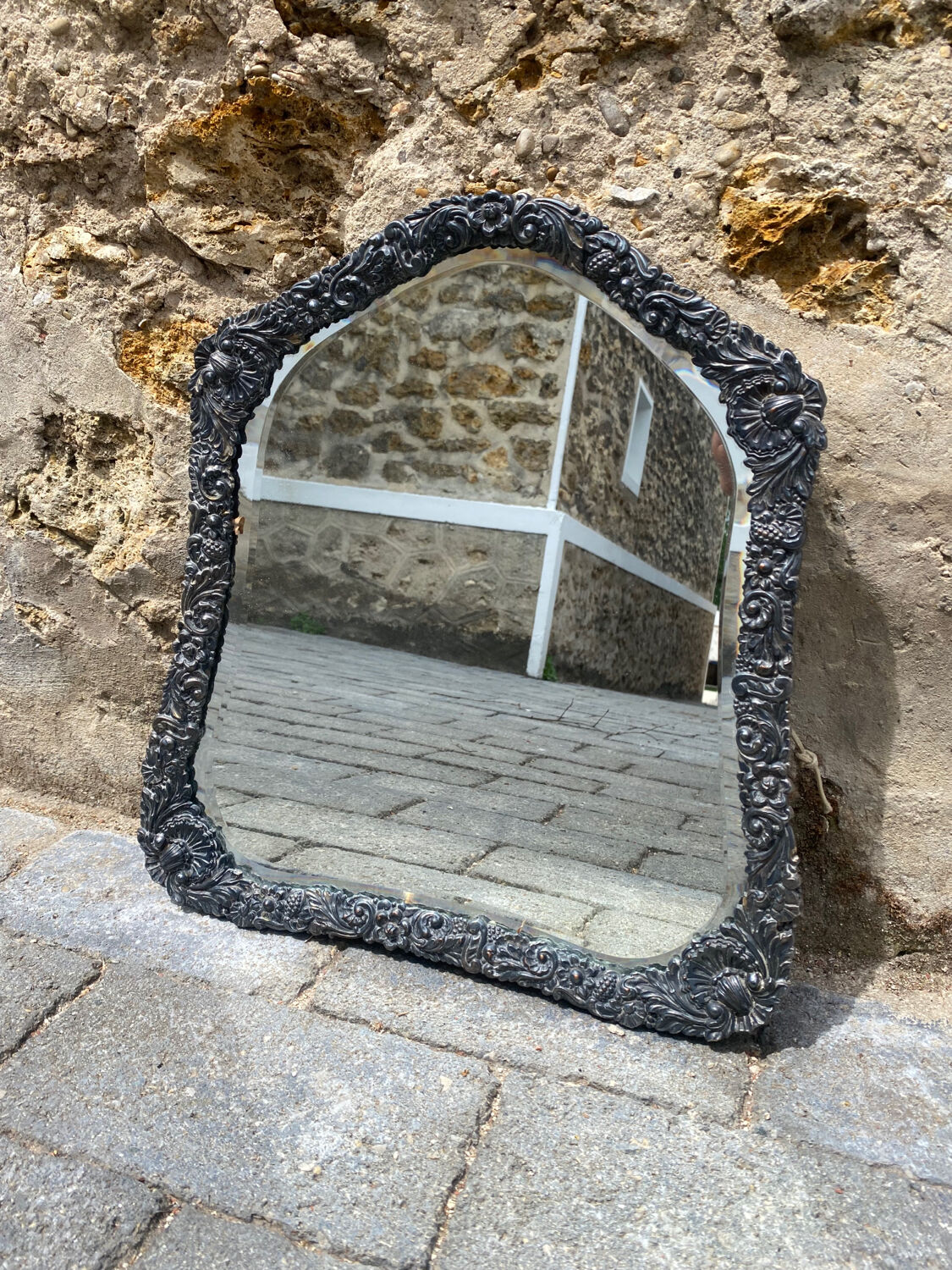Old mirror carved in gray metal