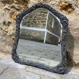 Old mirror carved in gray metal