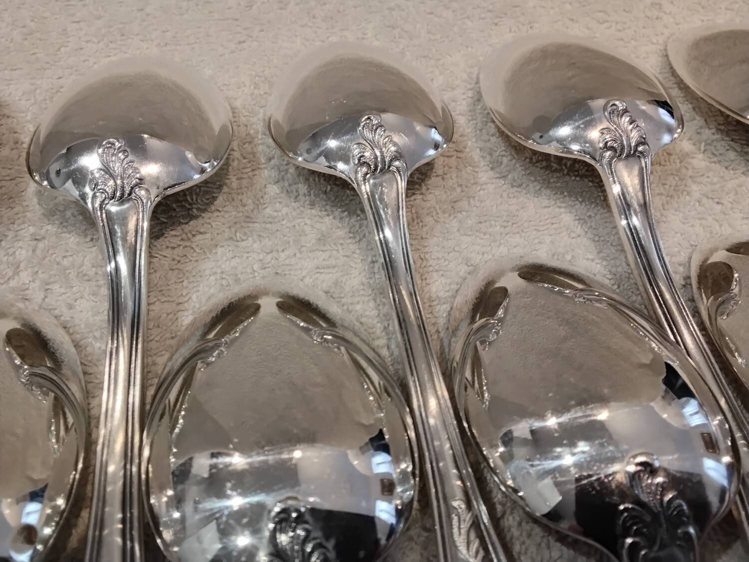 12 silver-plated metal soup spoons, Ercuis Dubarry model.
