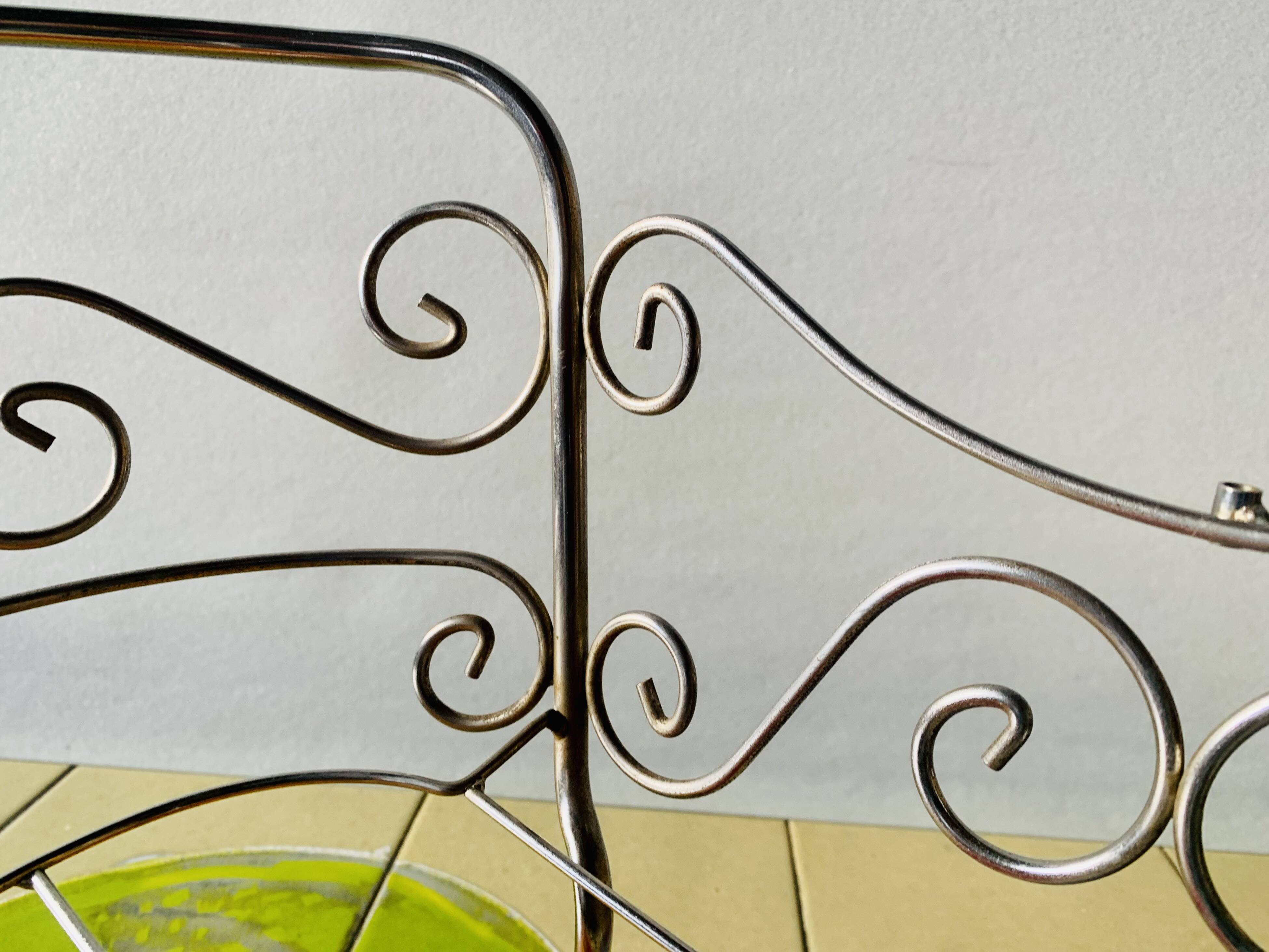 Metal doll's bed on vintage casters