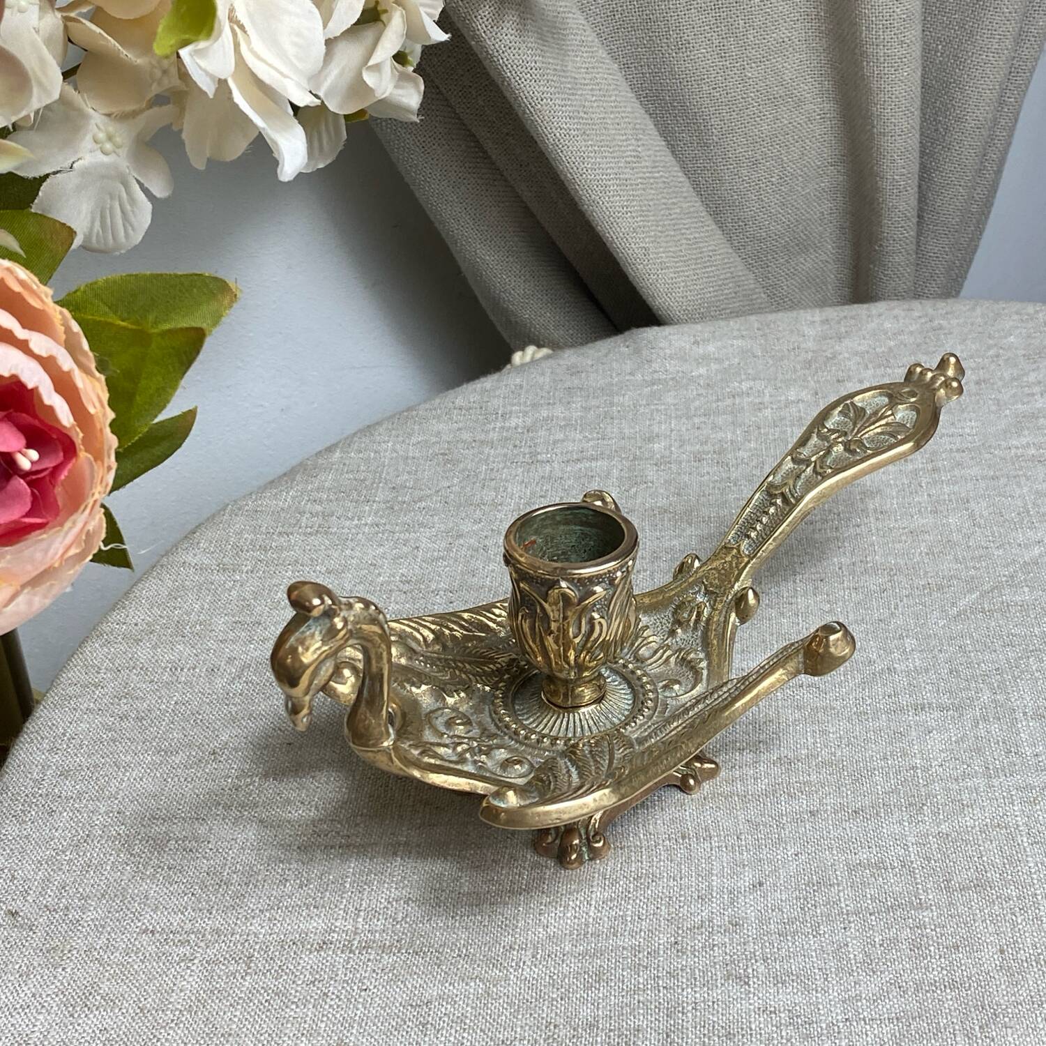 Bronze hand candlestick in the shape of a peacock