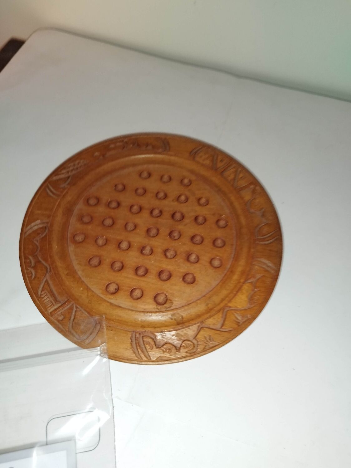 Ancient solitaire game in wood and stone marbles