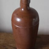 Vintage stoneware liqueur bottle with handle and spout.