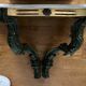 Carved wooden console and gray marble