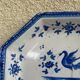 Antique octagonal plate in blue and white pottery with bird decoration.