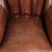 Comfortable sheepskin armchair in unique design finished with black piping