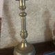 Large antique brass candlestick with floral decoration.