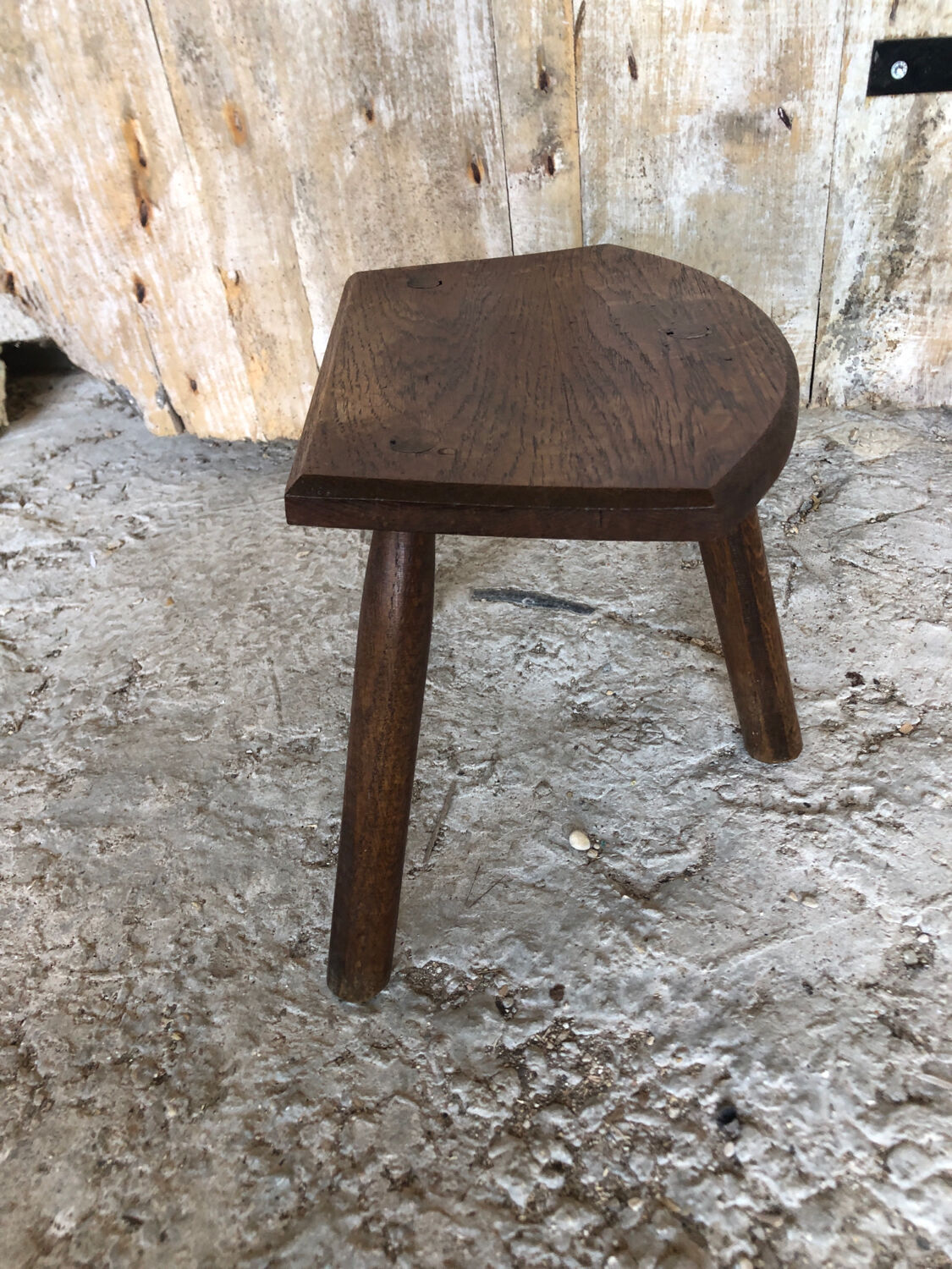 Old vintage wooden tripod milking stool