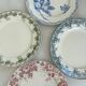 Lot of 4 dessert plates in pink, blue, and green ironstone, flat earthenware.