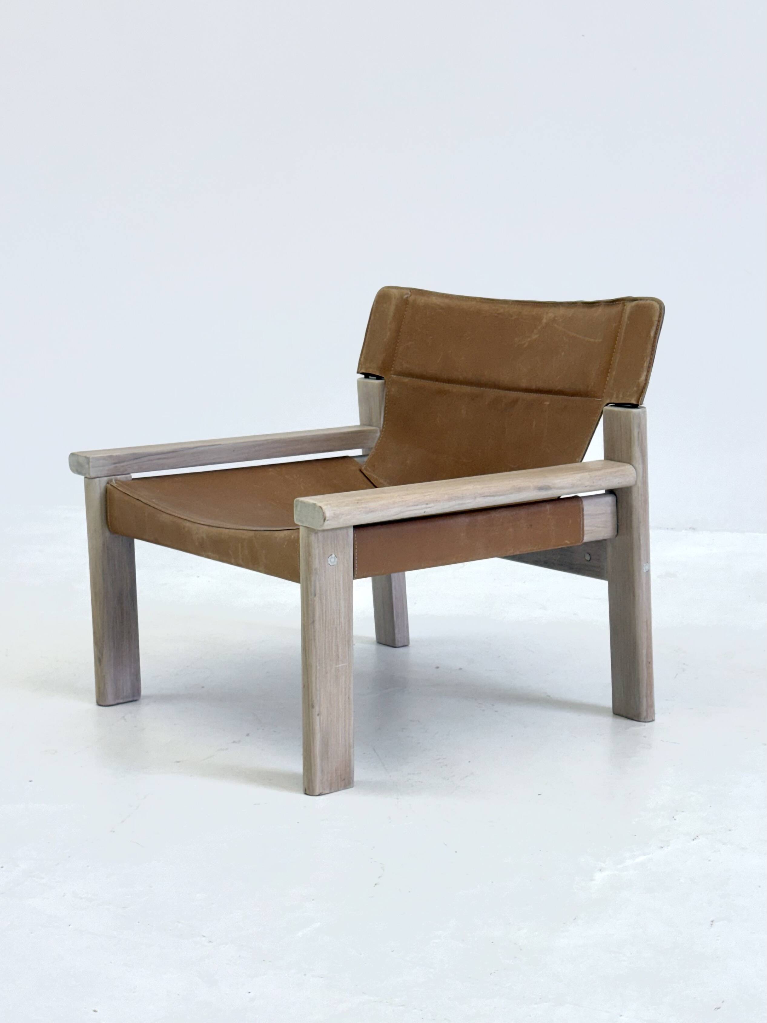 Stylish vintage armchair with saddle leather seat