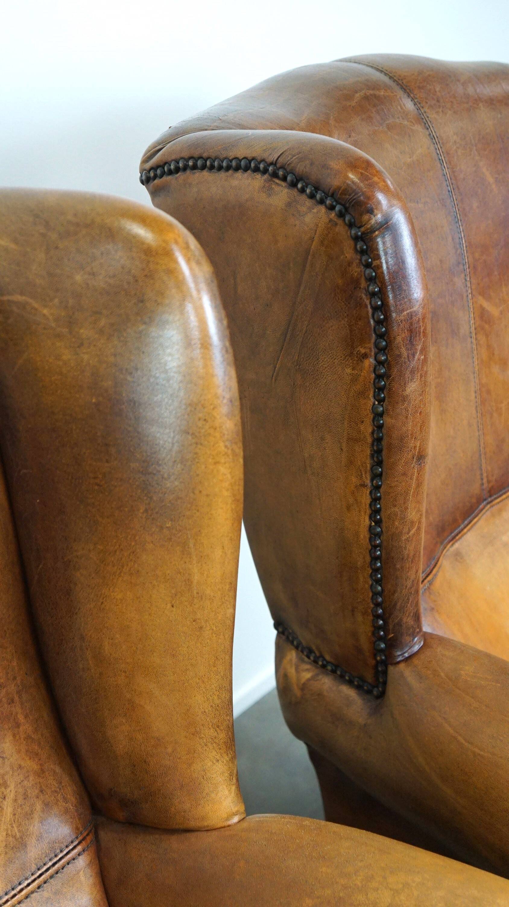 Set of 2 beautiful and correct sheep leather wingback armchairs with fixed seat cushions