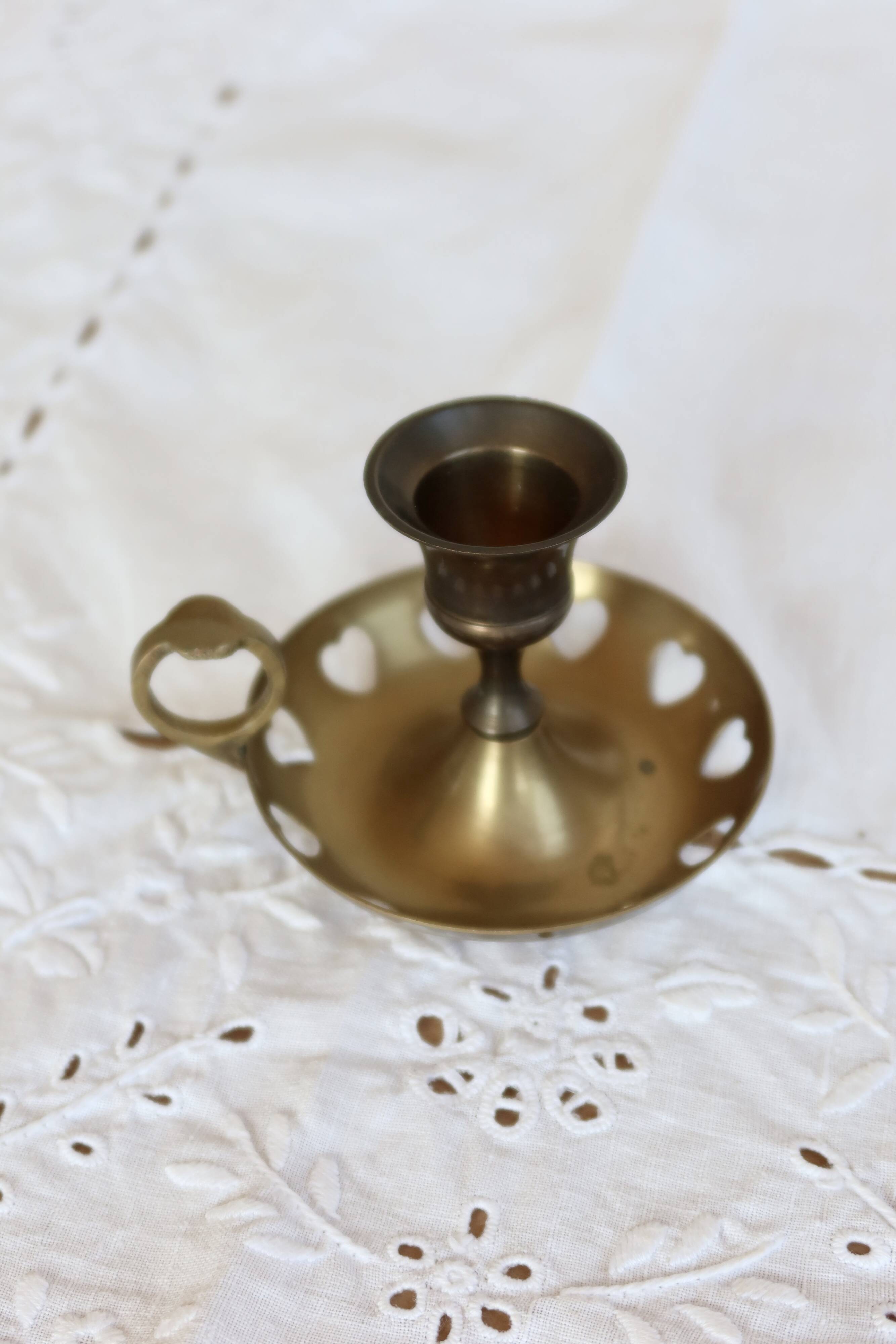 Antique brass rat trap with heart patterns.