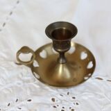 Antique brass rat trap with heart patterns.