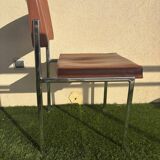 A pair of vintage brown Skaï chairs.