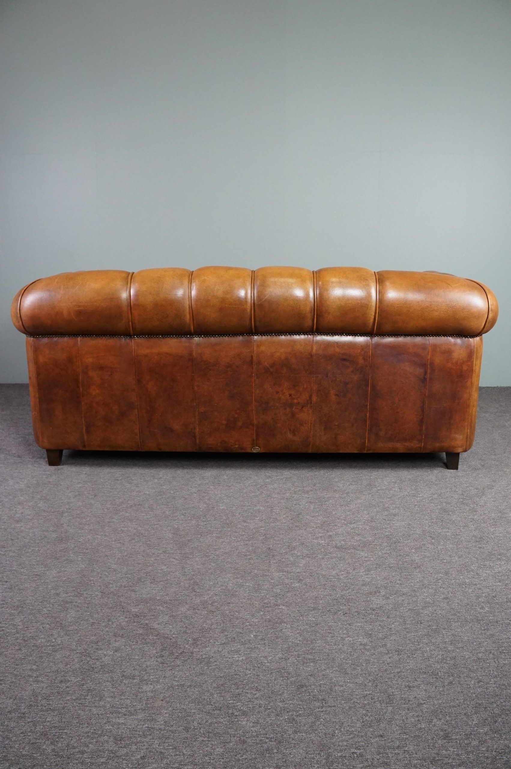 Sheepskin sofa with decorative nails