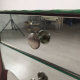 Glass art deco mirror beside table