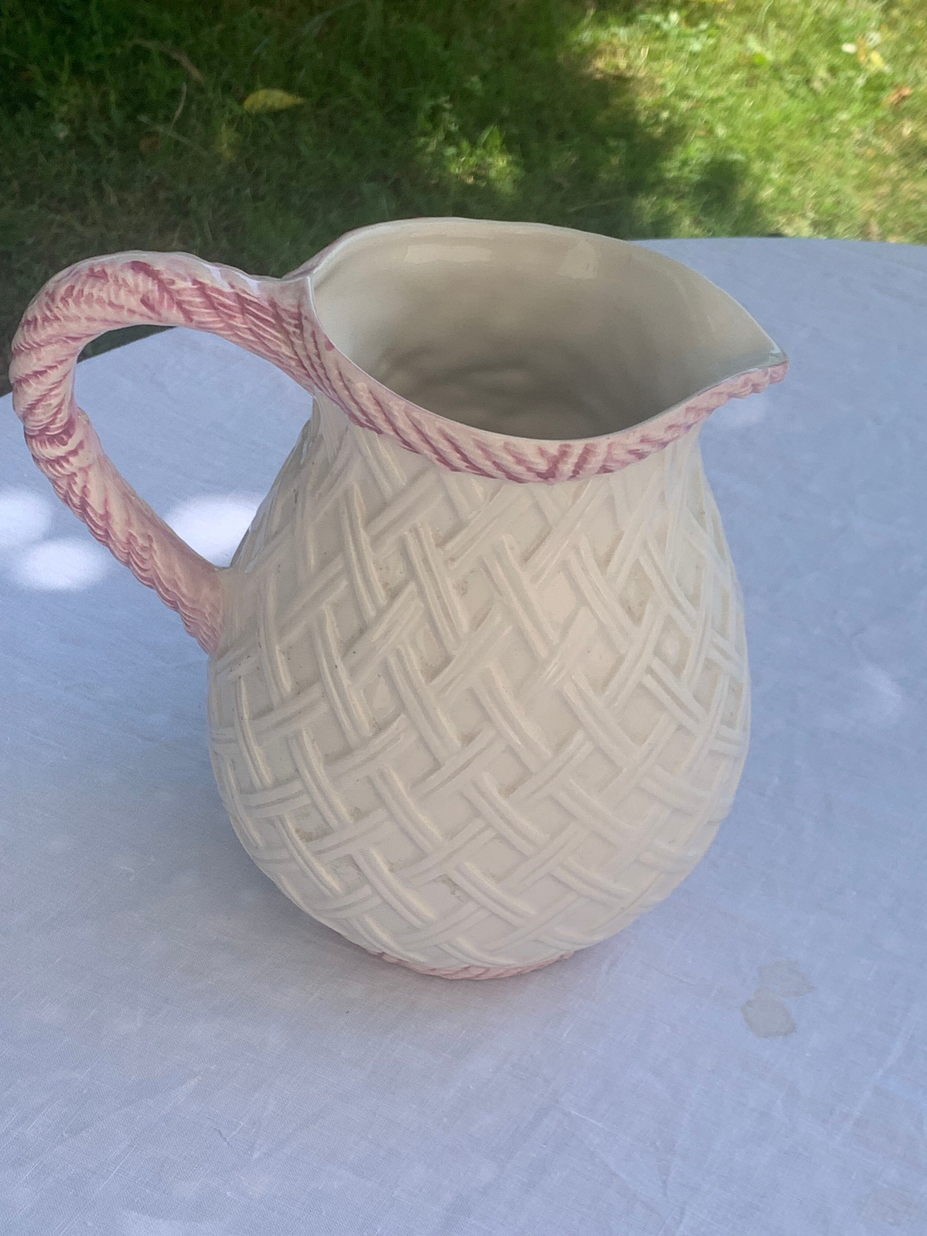Glazed ceramic slip jug with vintage basket and fruit motif