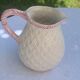 Glazed ceramic slip jug with vintage basket and fruit motif
