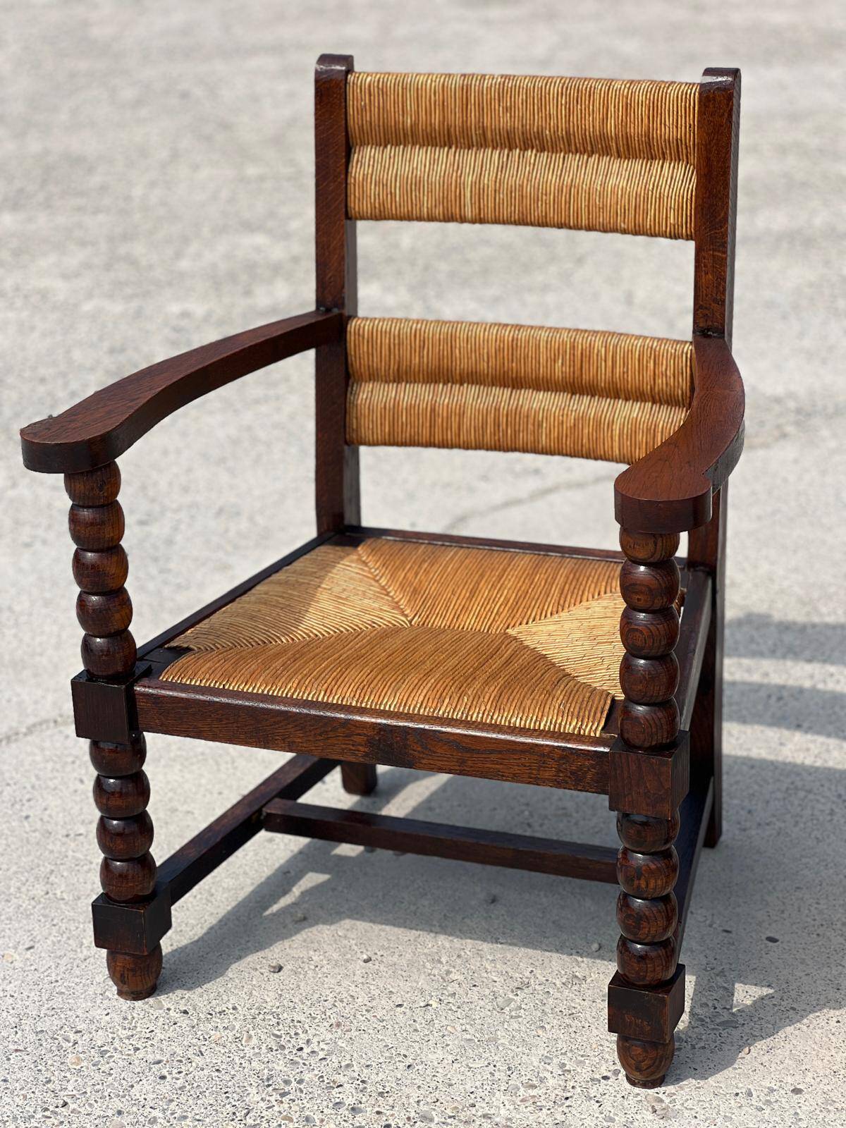 Pair of stained oak and straw armchairs, French work, 1950