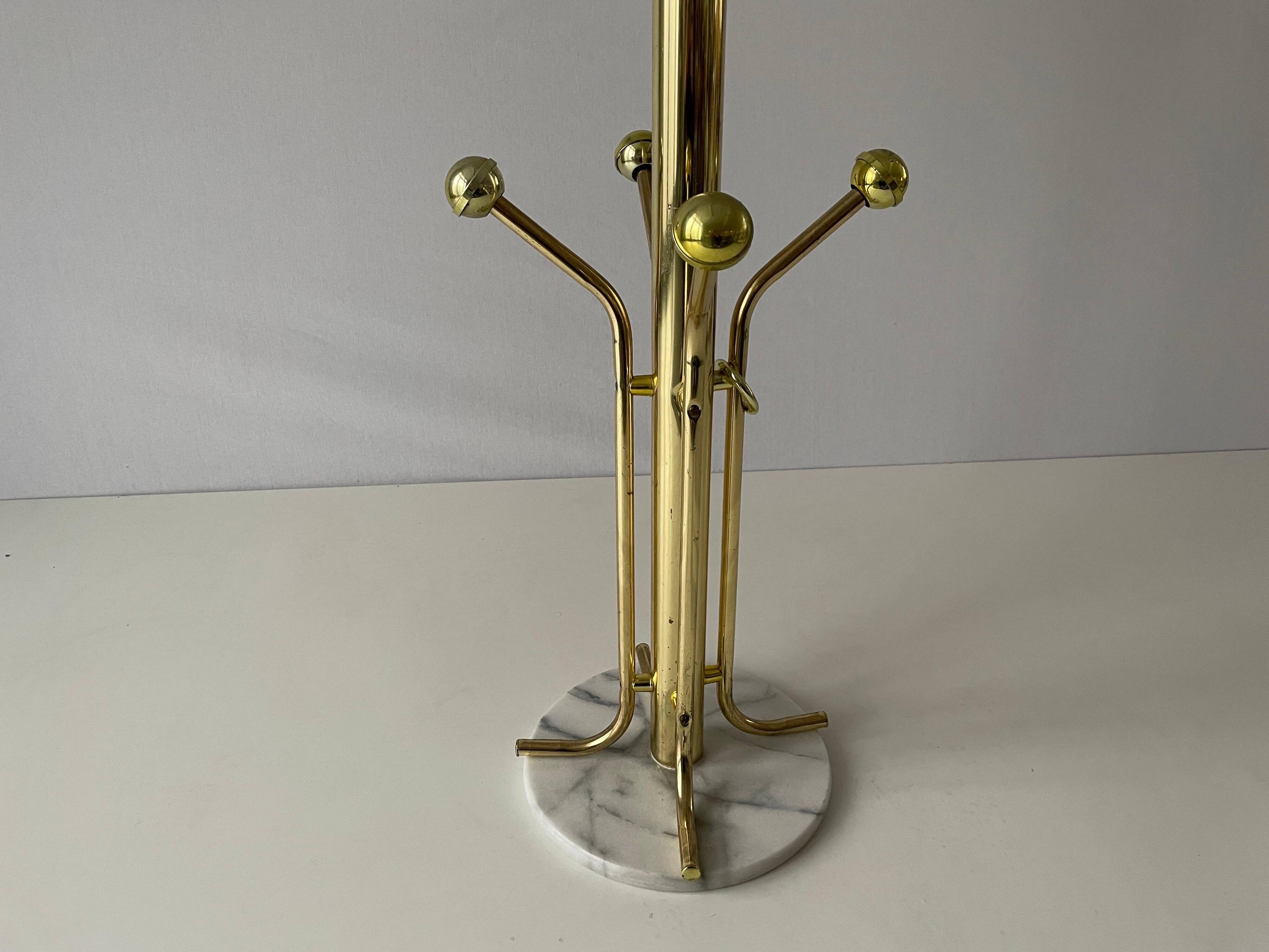 Free-standing coat rack in plexiglass with a marble base, 1960s, Germany.