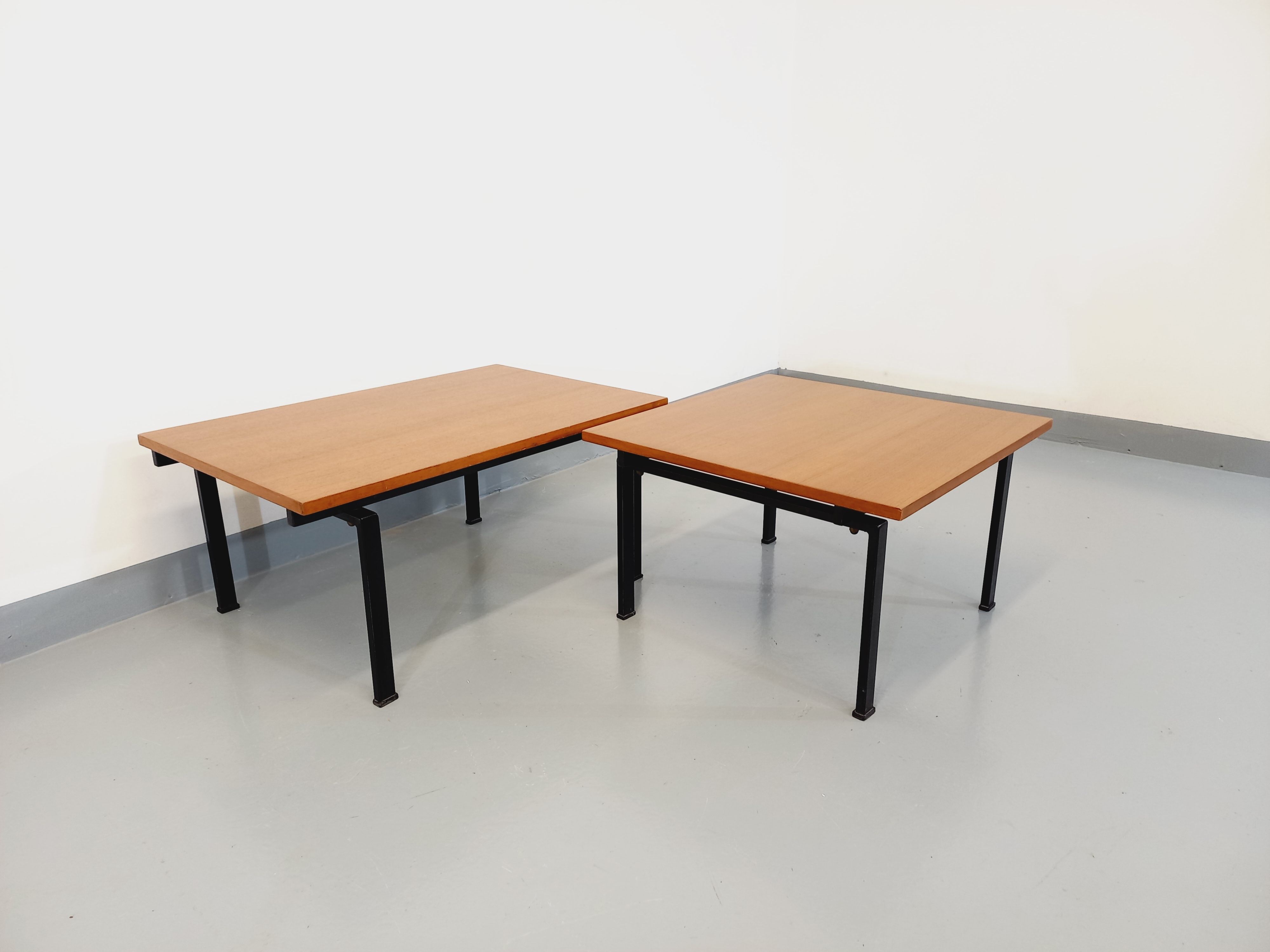 Suite of two vintage modernist Isa coffee tables in teak and black metal from the 60s